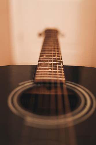 musical instrument close-up photograph of black dreadnought acoustic guitar guitar